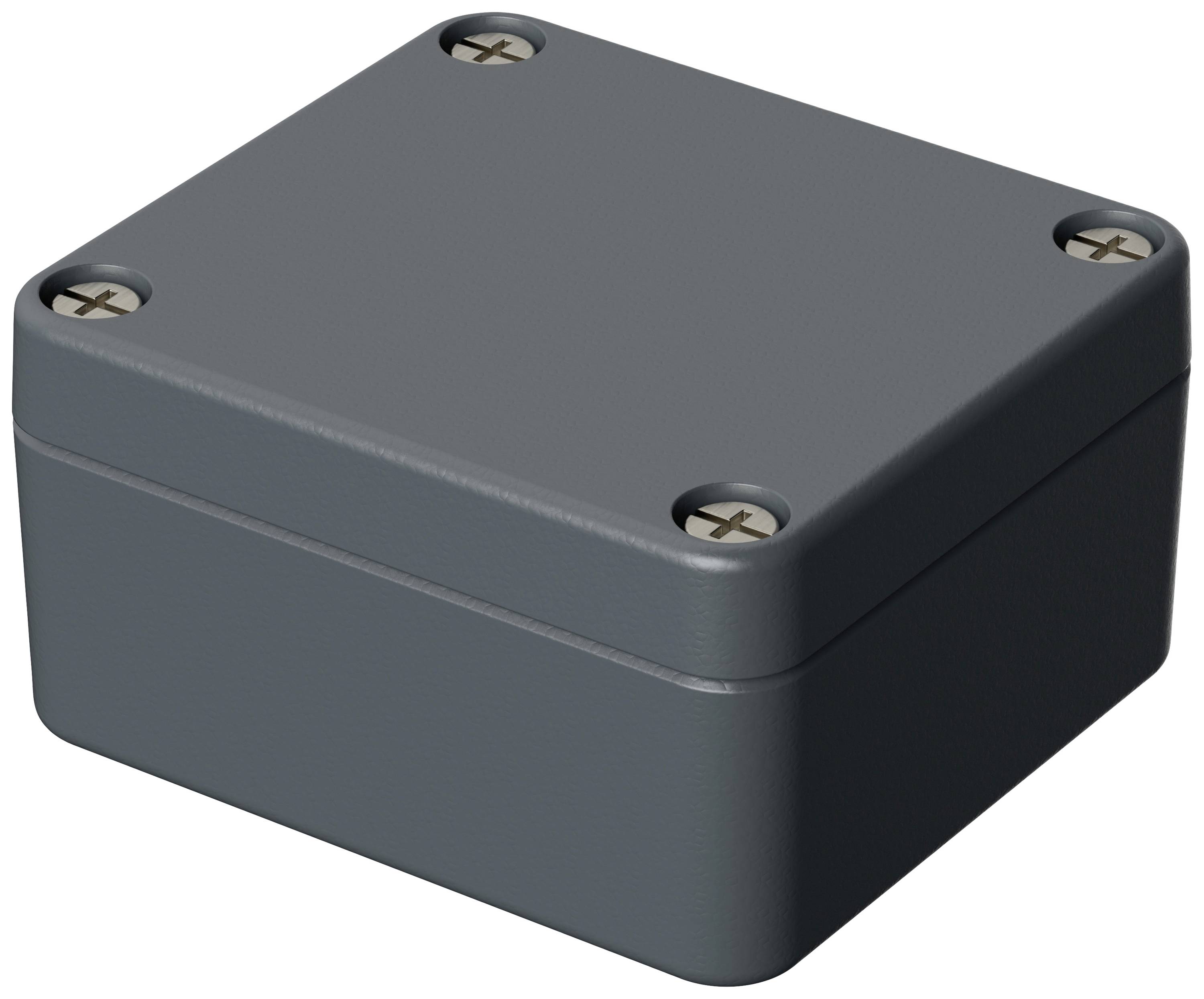 Ein rechteckiges, dunkelgraues Gehäuse mit vier Schrauben an den Ecken; möglicherweise eine Elektronikbox.