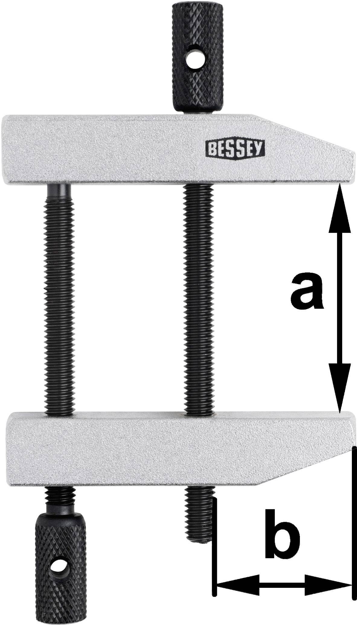 Vertikale Schraubzwinge mit zwei schwarzen Gewindespindeln, die parallele Aluminiumschienen verbinden. Maße 'a' und 'b' markiert.