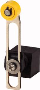 Ein mechanisches Bauteil mit gelber Rolle oben und schwarzem quadratischen Block unten, verbunden durch eine silberne Halterung.