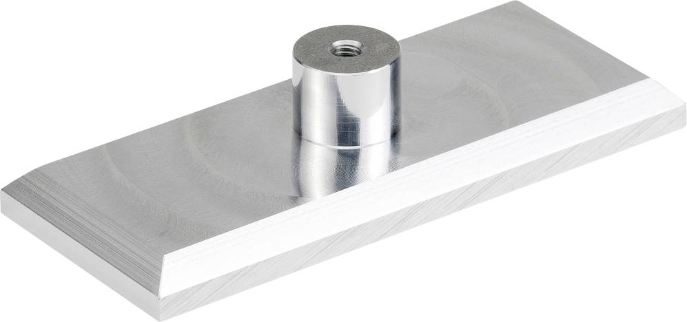 Ein rechteckiges, silbernes Metallteil mit einer zylindrischen Erhöhung in der Mitte.