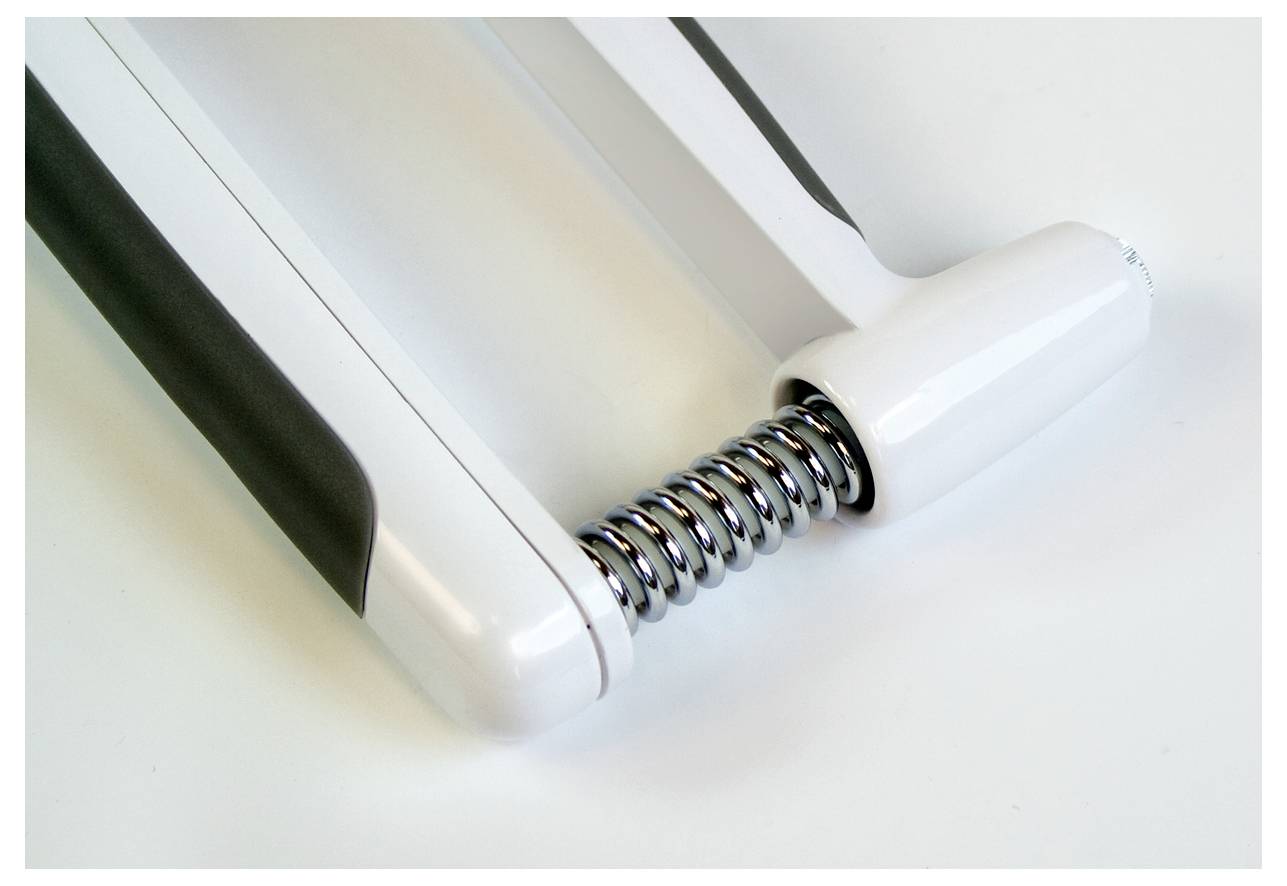 Ein Handmuskeltrainer aus weißem Kunststoff mit einem silbernen Federmechanismus in der Mitte, zur Stärkung der Handmuskulatur.