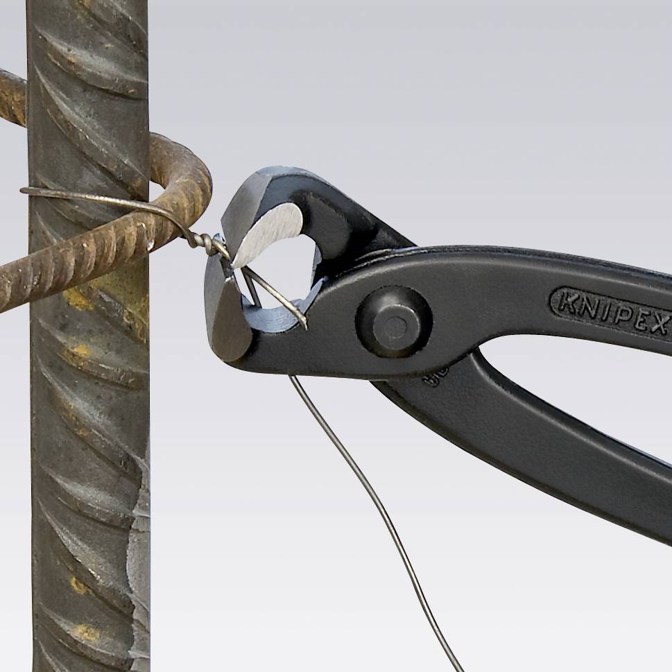 Zange schneidet Draht durch, der um eine Stahlstange gewickelt ist. Die Knipex-Zange wird zum Trennen von starkem Draht verwendet.