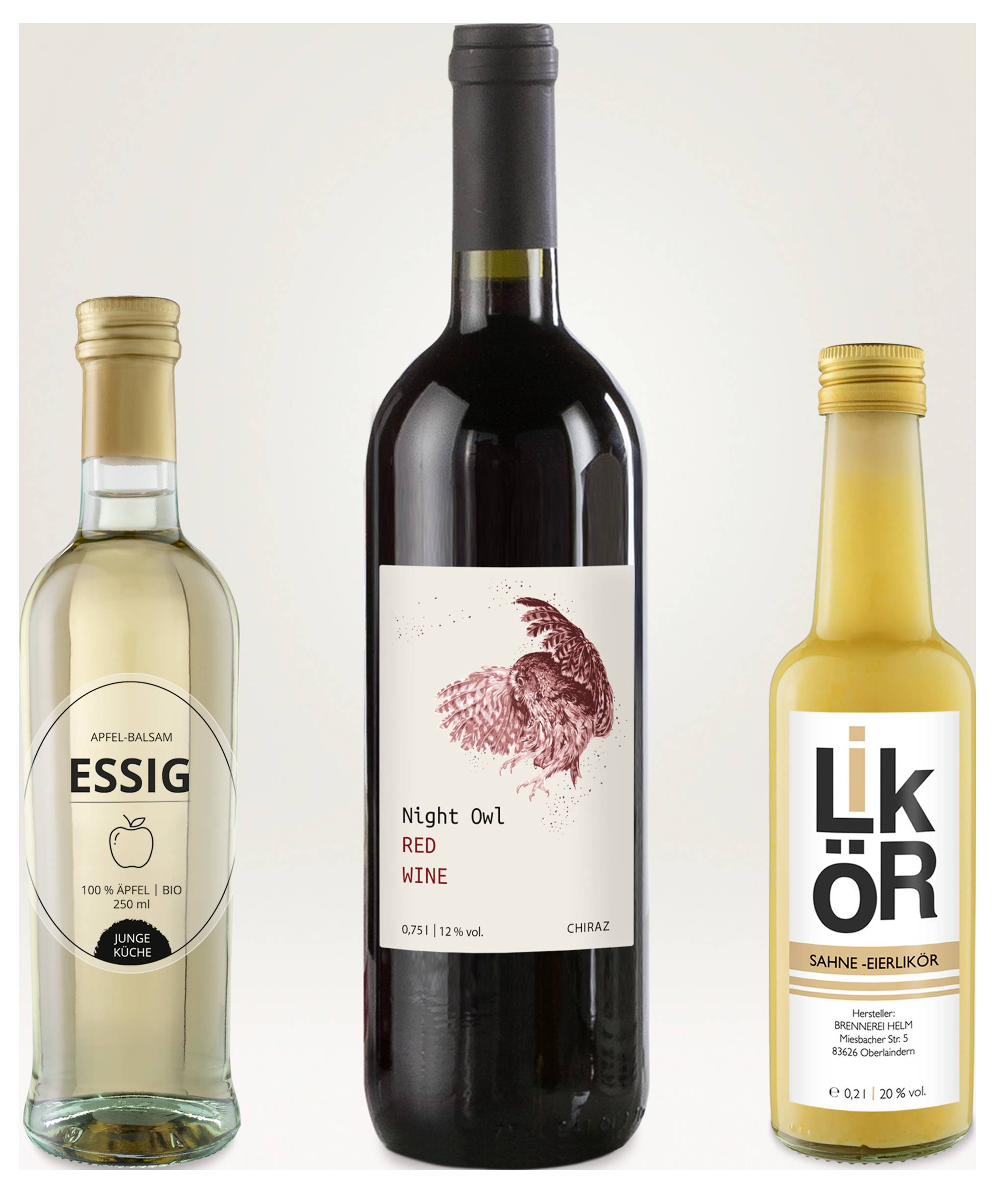Drei Flaschen: Apfelessig links, Rotwein 'Night Owl' in der Mitte und Sahne-Likör rechts, jeweils mit Etikett vor hellem Hintergrund.