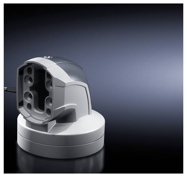 Ein graues Ladegerät ohne eingelegtes Gerät, auf einer dunklen Oberfläche stehend, beleuchtet vor einem dunkelblauen Hintergrund.