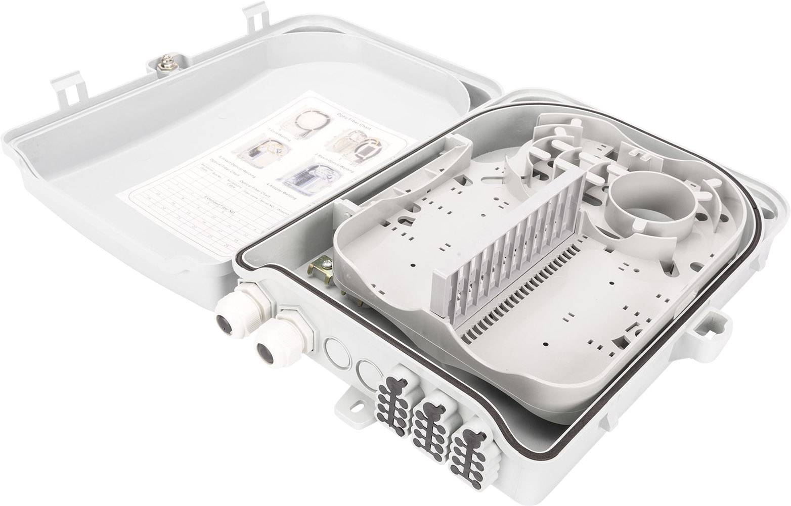 Ein geöffneter Verteilerkasten mit Kabelanschlüssen und einem Fach für elektronische Komponenten, auf einer Oberfläche abgelegt.