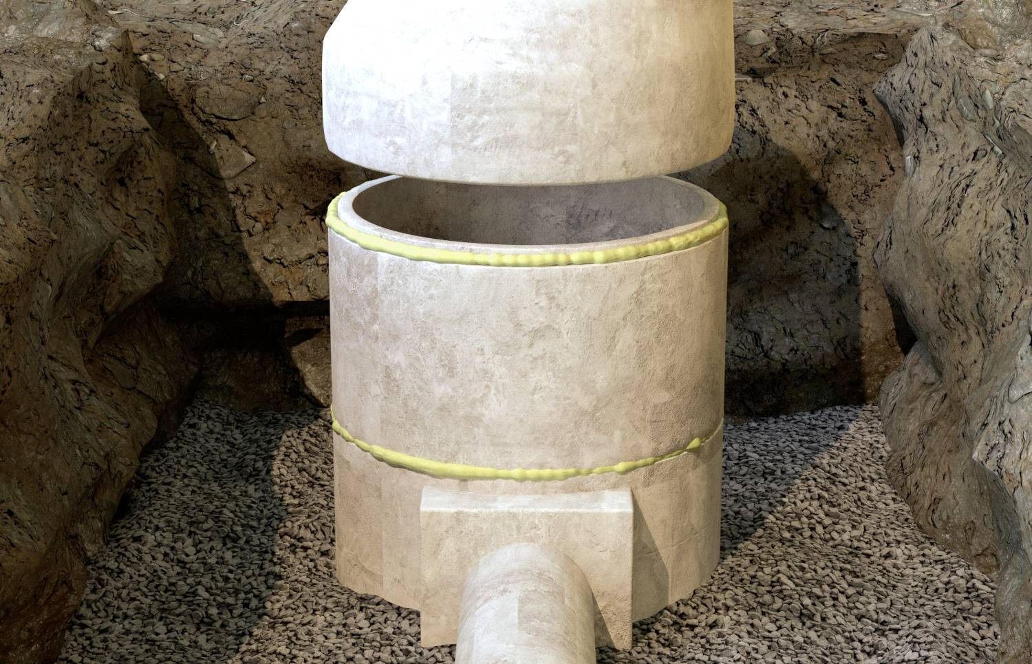 Eine große, graue Steinstruktur mit rundem Deckel befindet sich in einer felsigen Umgebung.