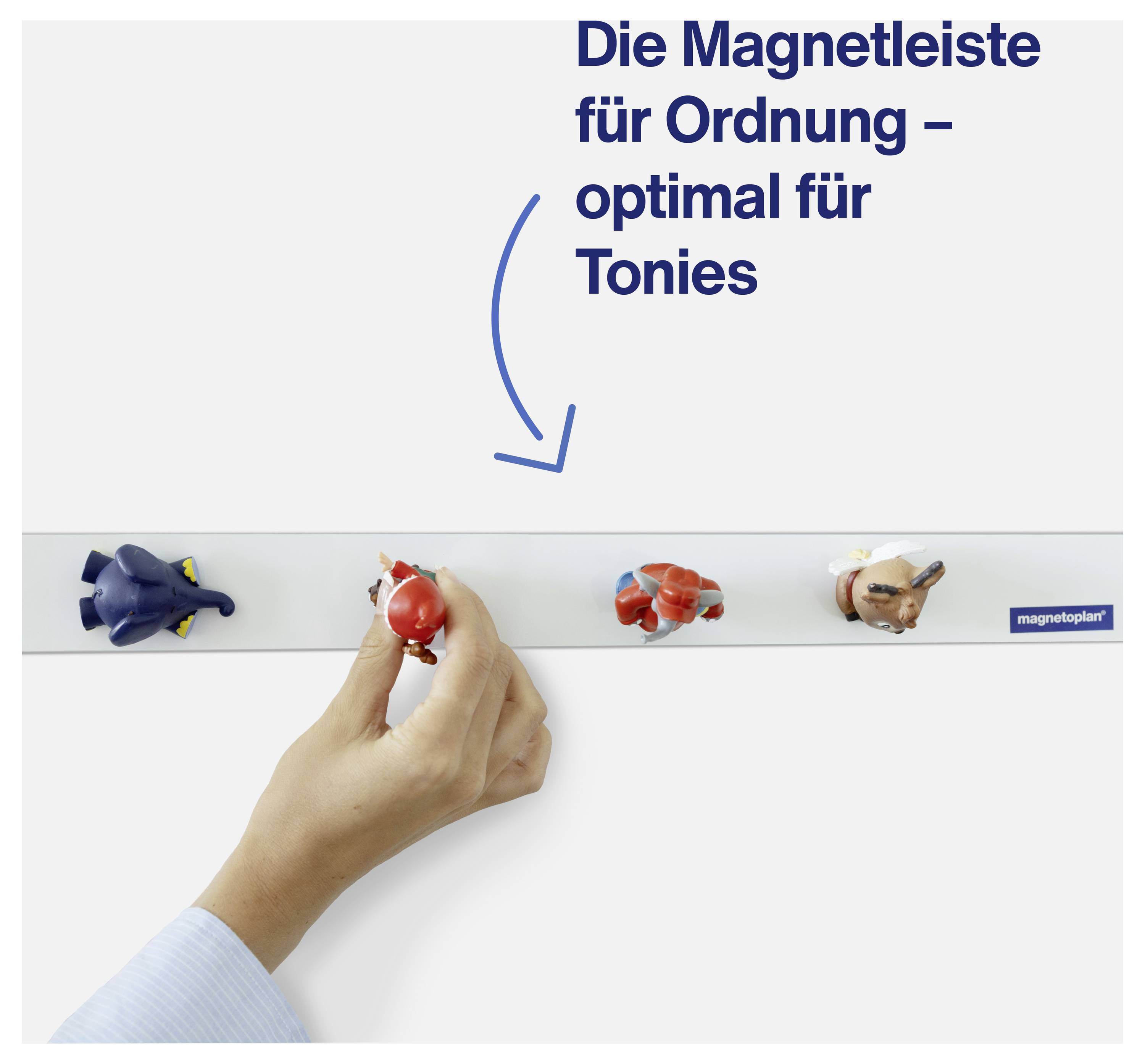 Eine Hand platziert eine Figur auf einer weißen Magnetleiste. Oben steht der Text: 'Die Magnetleiste für Ordnung - optimal für Tonies'.