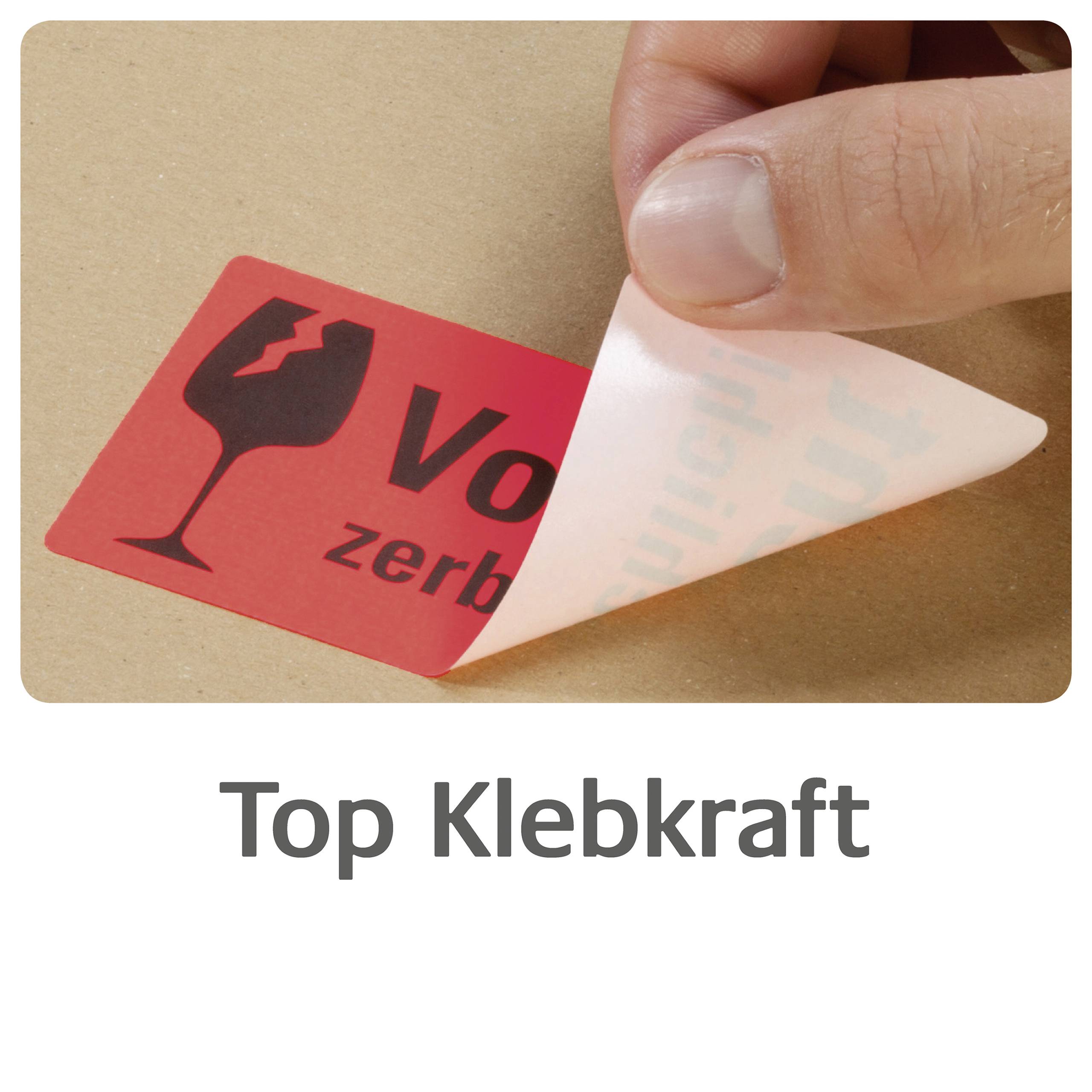 Etikett mit Aufschrift 'Vorsicht zerbrechlich' wird von einer Hand abgezogen. Text unten: 'Top Klebkraft'.