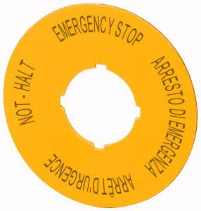 Gelbes Schild in Form einer Scheibe mit der Aufschrift 'EMERGENCY STOP', 'NOT–HALT', 'ARRESTO DI EMERGENZA' und 'ARRET D'URGENCE'.