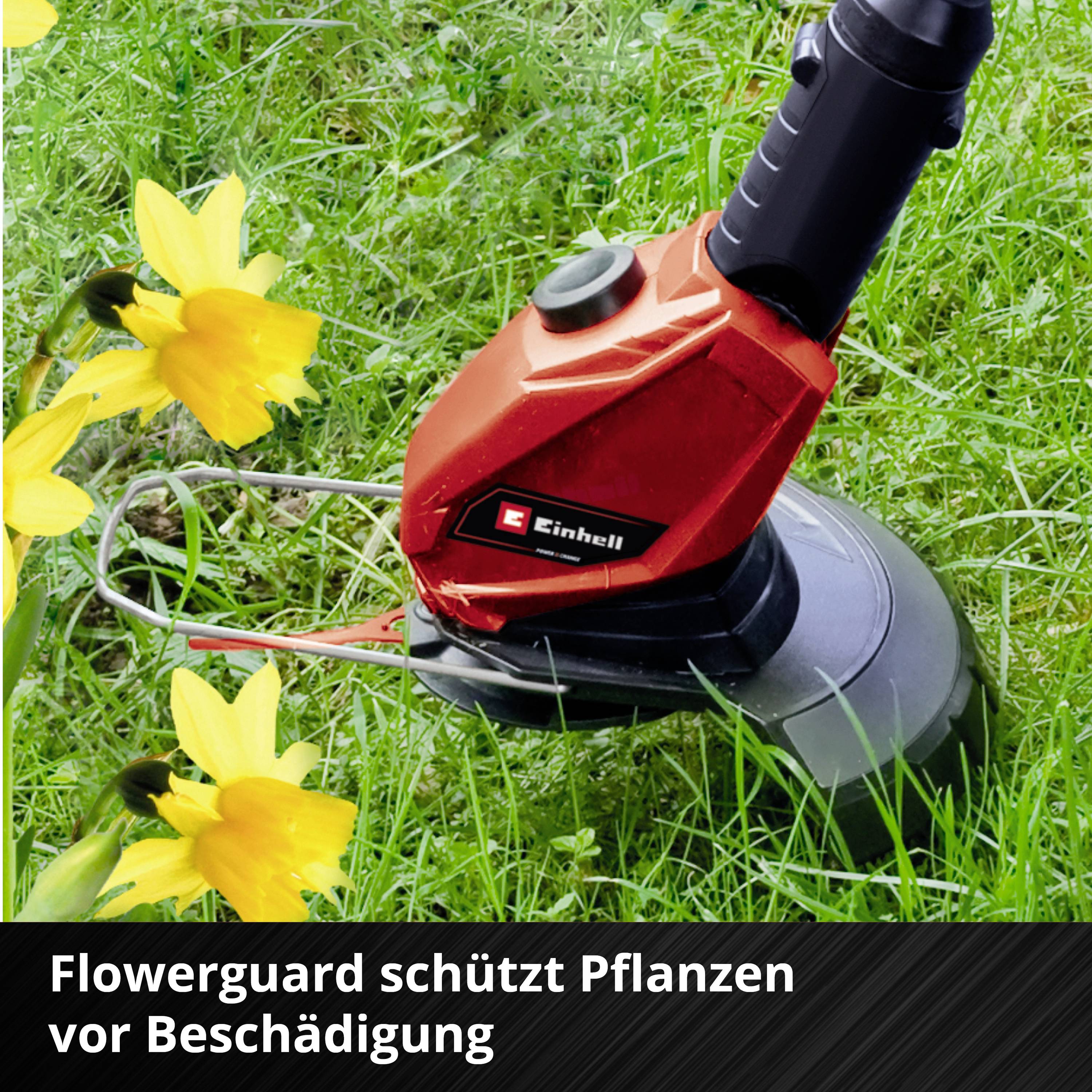 Roter Rasentrimmer auf grünem Gras mit gelben Blumen. Text darunter: 'Flowerguard schützt Pflanzen vor Beschädigung'.