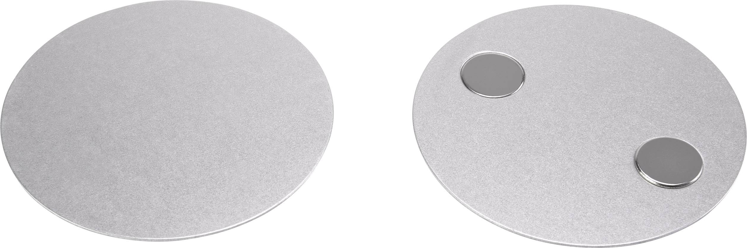 Zwei runde silberne Platten nebeneinander; die rechte hat zwei kleine, erhabene Kreise darauf.