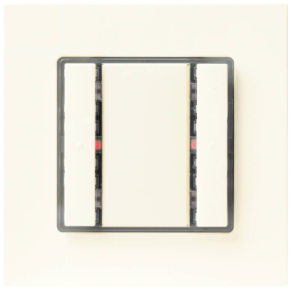 Ein Lichtschalter mit drei Druckplatten in einem rechteckigen Rahmen an einer beigen Wand.