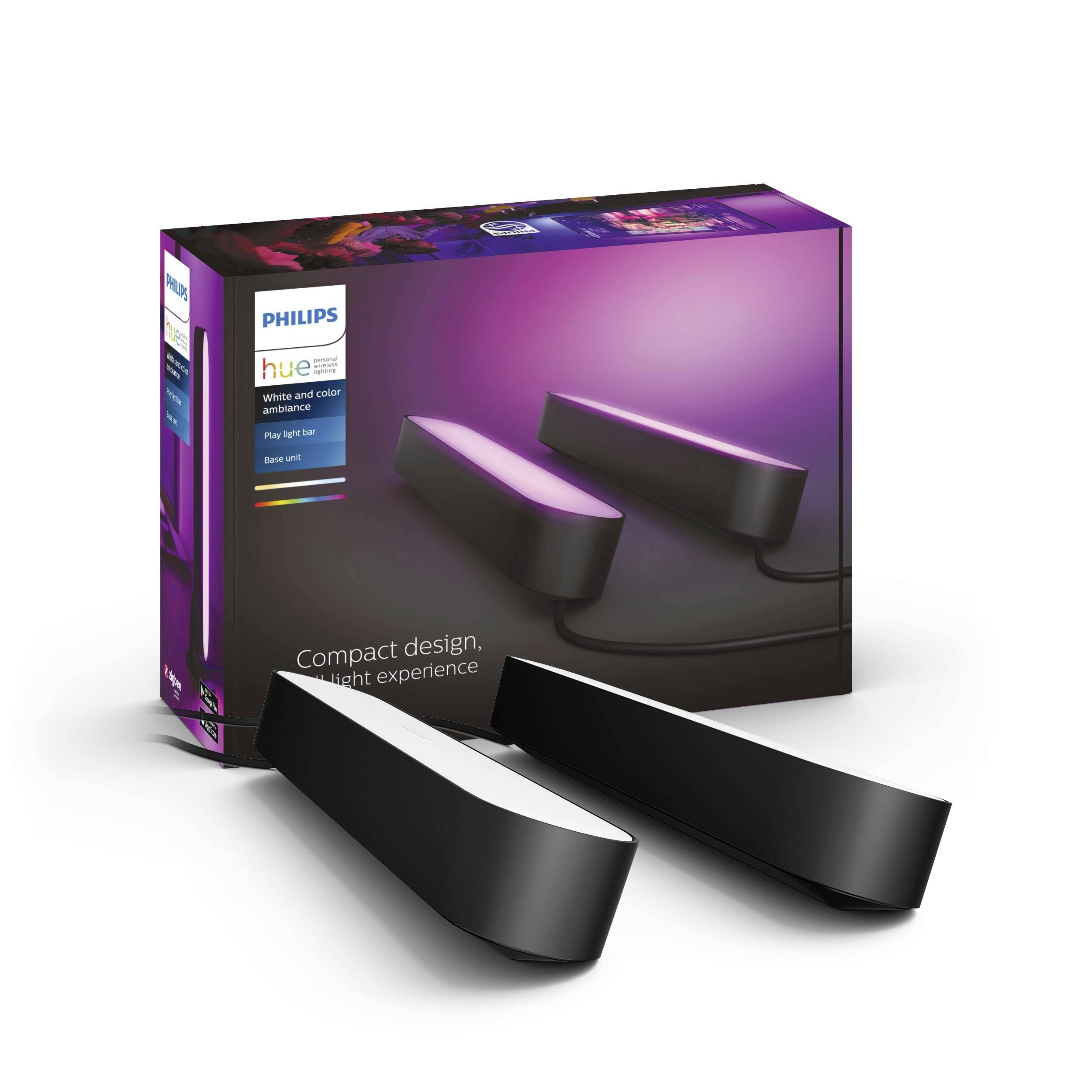 Zwei Philips Hue Play Lichtleisten vor der Produktverpackung. Die Leuchten sind schwarz und erzeugen violettes Licht.