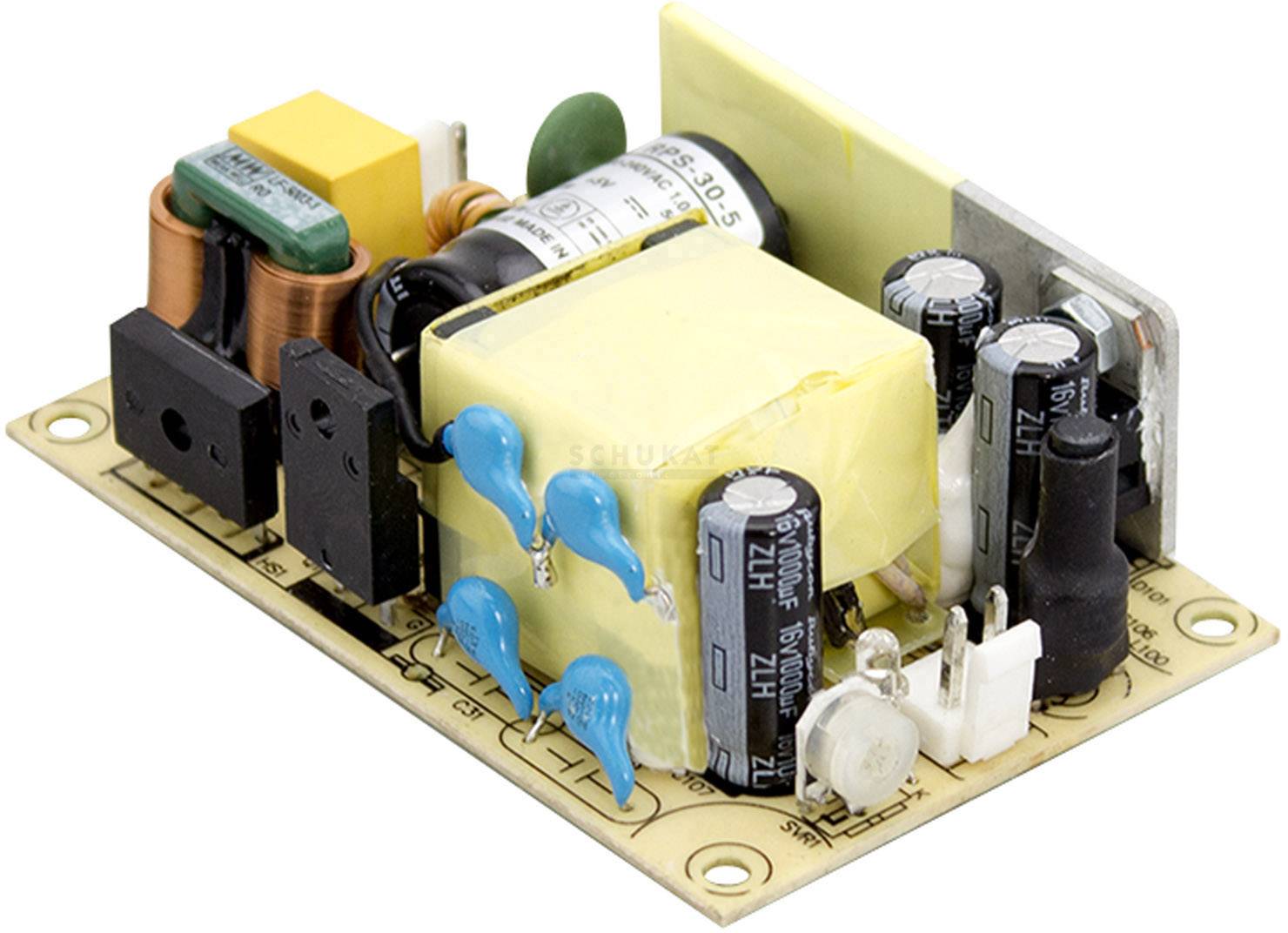 Elektronische Platine mit verschiedenen Bauteilen wie Spulen, Kondensatoren und Widerständen auf einem braunen Träger.