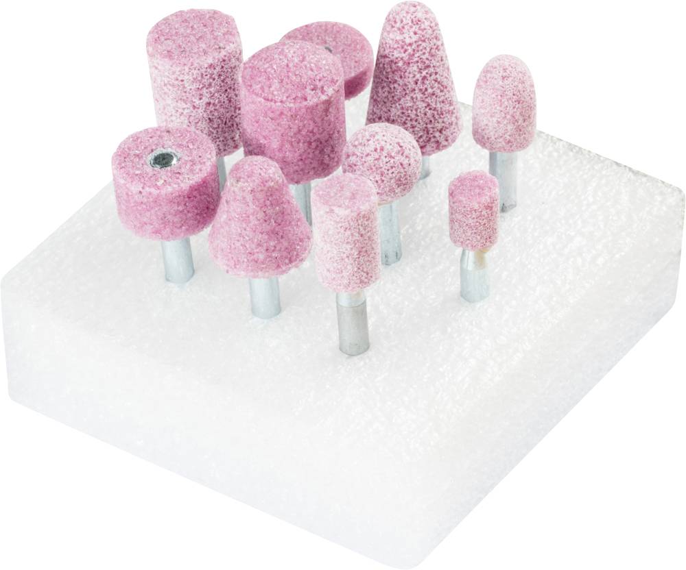 Verschiedene rosa Schleifaufsätze in unterschiedlichen Formen und Größen auf einer weißen Schaumstoffunterlage. Hauptsächlich zylindrische und konische Formen.