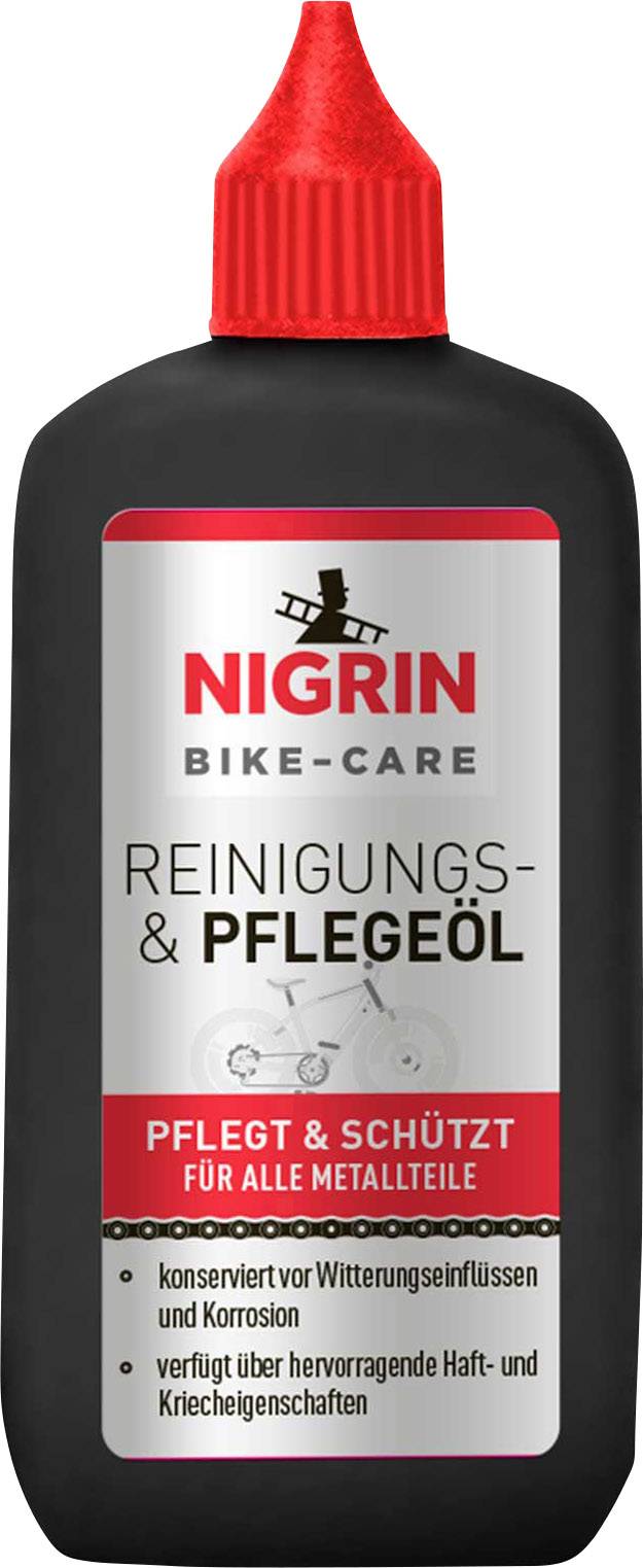 Schwarze Flasche Nigrin Bike-Care Reinigungs- und Pflegeöl mit rotem Deckel. Text: 'Pflegt & schützt für alle Metallteile'.