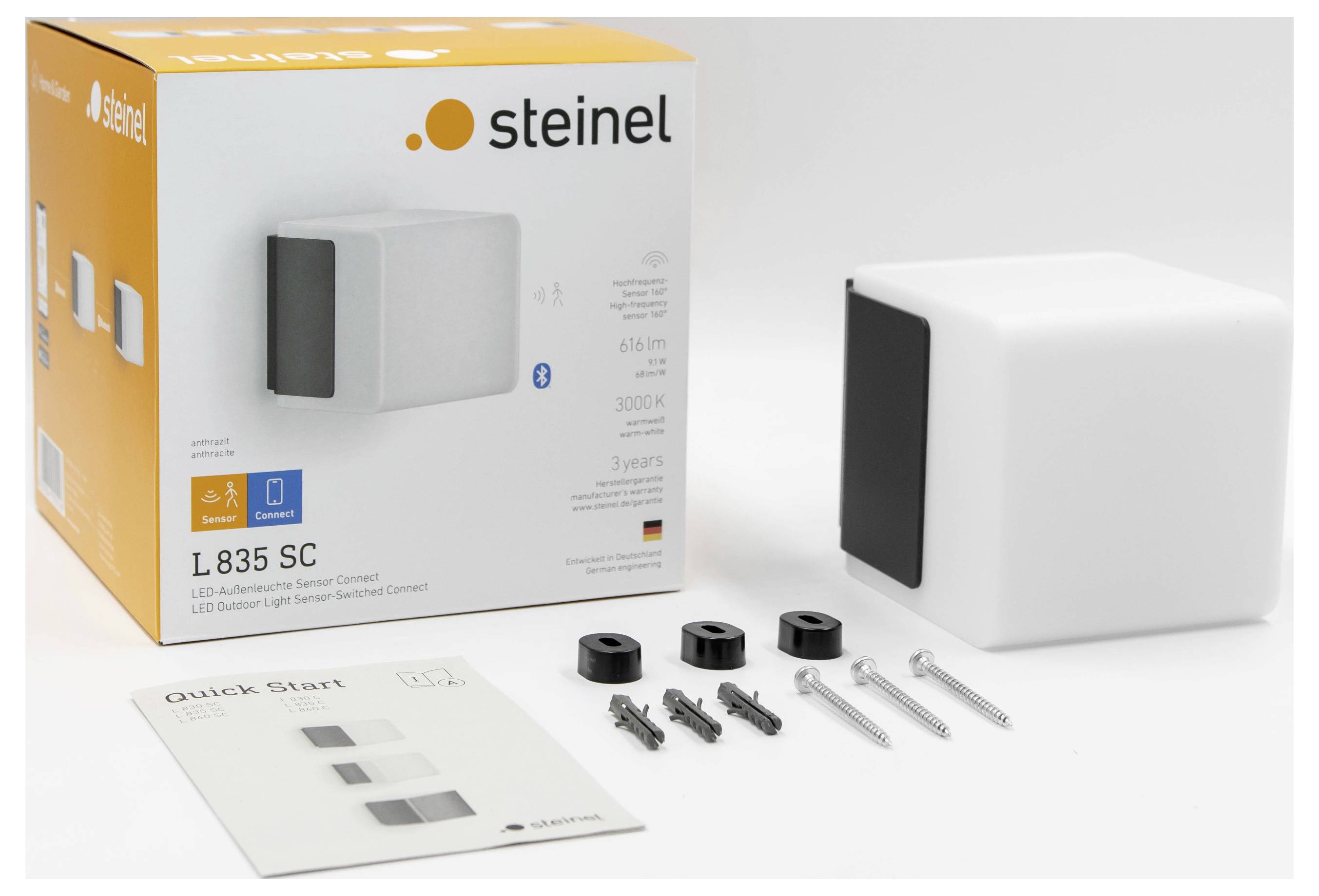 Steinel L835 SC LED-Außenwandleuchte mit Produktverpackung, weißer Leuchte, Schnellstartanleitung und Montagezubehör.