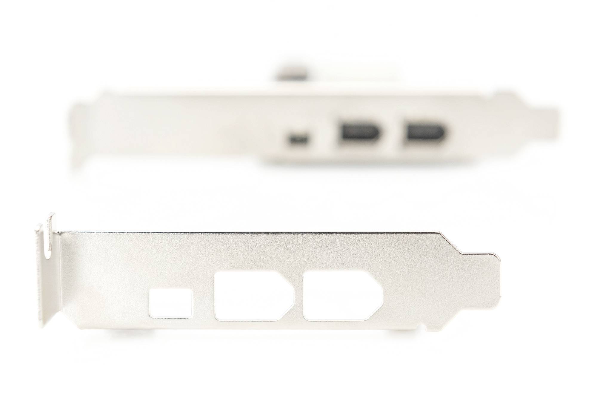 Zwei silberne Computer-Slotblenden in Unschärfe. Vordergrundfokus auf lochengestanztes Blech, Hintergrund mit USB-Anschlüssen.