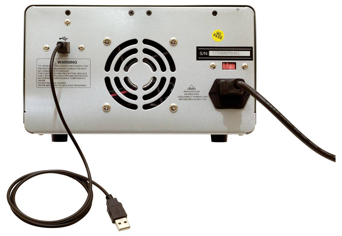 Rückseite eines elektronischen Geräts mit Lüftungsgitter, Kabelanschlüssen und USB-Kabel; Warnhinweise und Seriennummer sichtbar.