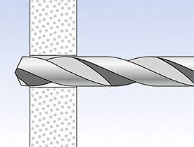 Ein Bohrer bohrt durch eine Wand. Der Bohrer ist teilweise sichtbar und von links nach rechts ausgerichtet.