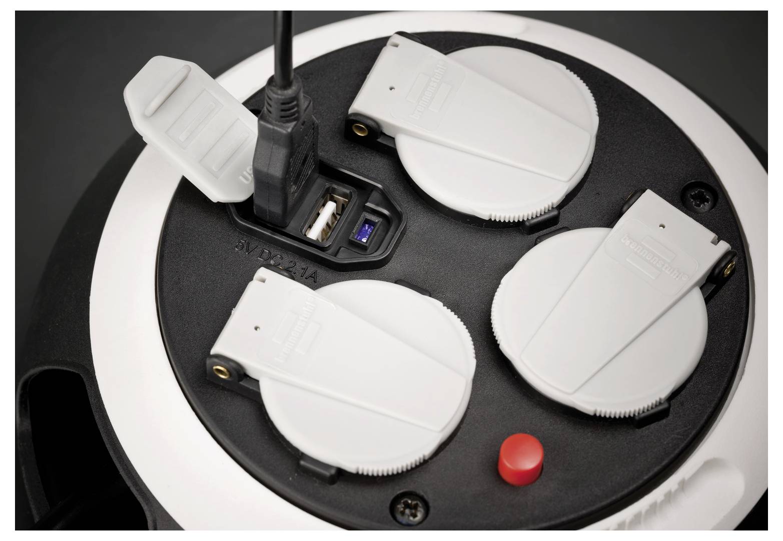 Draufsicht auf eine kreisförmige schwarze Ladestation mit vier weißen kabellosen Mauseladestationen, einem angeschlossenen USB-Kabel und einem roten Knopf.