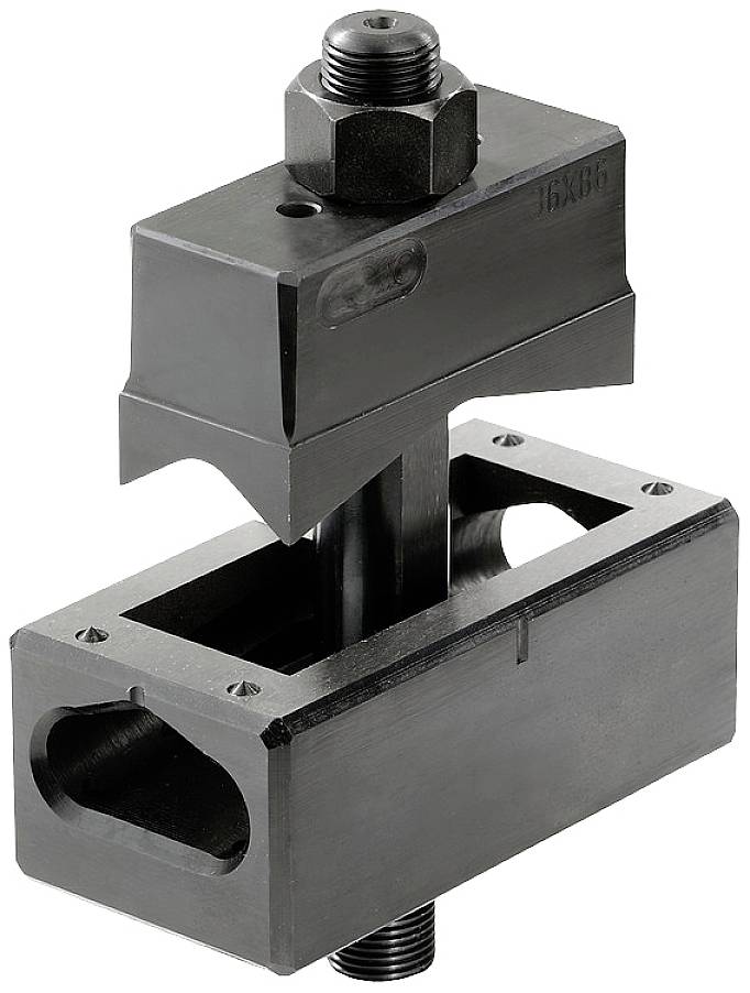 Ein schwarzes Maschinenwerkzeug mit einem massiven Block oben, befestigt durch eine Schraube. Darunter ein rechteckiger, hohler Teil.