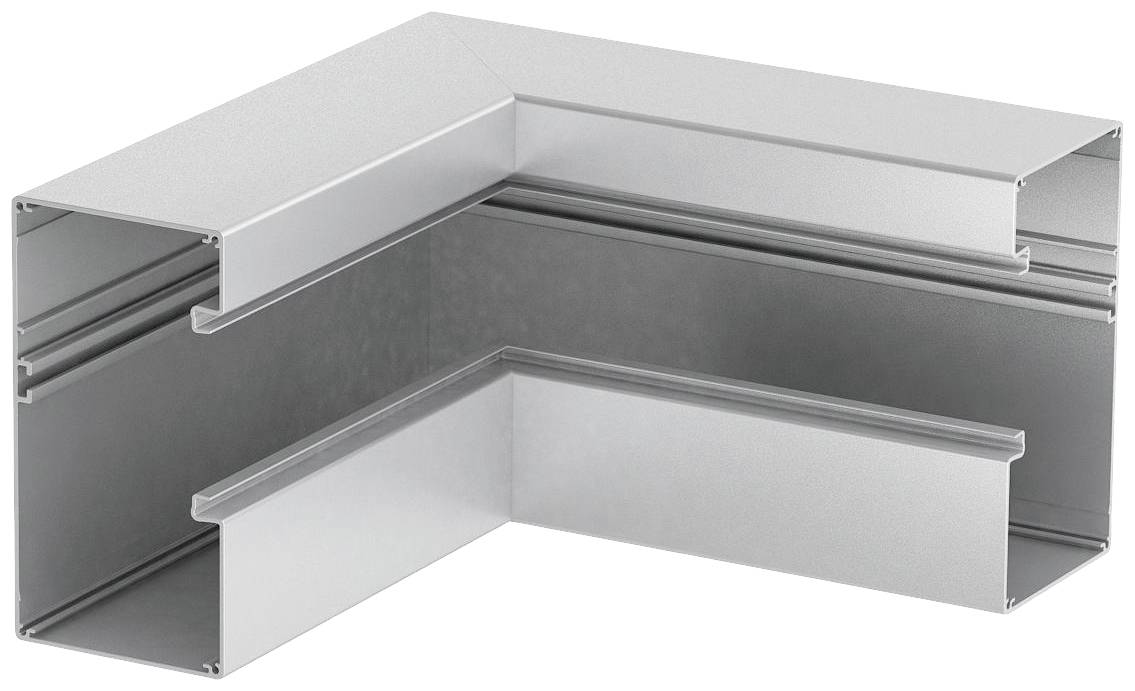 Metallisches Lüftungselement in L-Form mit glattem, silbrigem Finish. Geeignet für die Verbindung von Kanälen in Gebäuden.