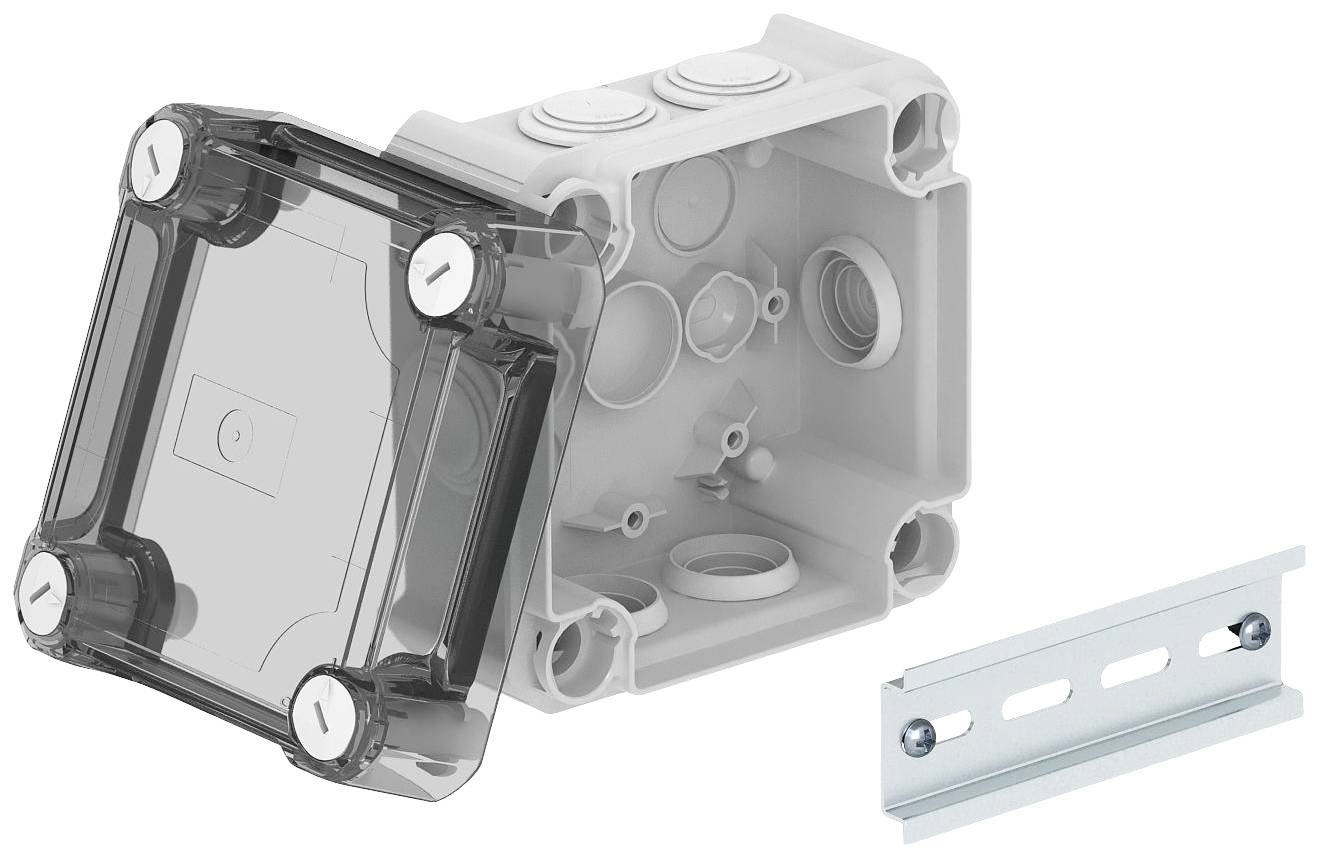 Elektrischer Verteilerkasten mit transparentem Deckel; interne Aussparungen und Kabelöffnungen sichtbar. Metallhalterung daneben.