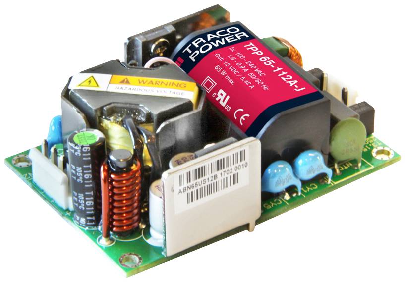 Elektronisches Netzteil-Modul mit Kühlkörper, Spulen und blauen Kondensatoren auf einer Platine; Hersteller: TRACO Power.