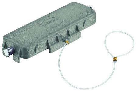 Ein grauer Kabeldämpfer mit zwei Kabelanschlüssen. Das Gerät hat eine längliche Form und ist mit einem dünnen Kabel verbunden.