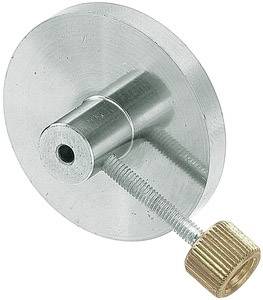 Ein silbernes Metallscheibe mit einem mittigen Zylinder und einer Schraube mit goldfarbenem Knopf an der Seite.
