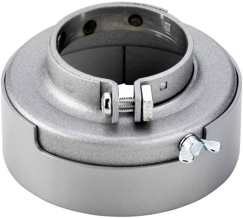 Ein silbernes Metallteil mit einer ringförmigen Struktur und einer Schraubklemme. Es sieht aus wie eine Mechanikkomponente.