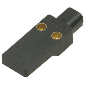 Ein schwarzer rechteckiger Drucksensor mit zwei goldenen Kontaktpunkten, Kabelanschluss rechts oben.