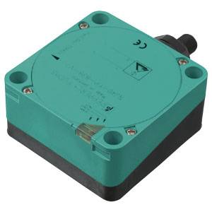 Ein quaderförmiger, türkisfarbener Sensor mit schwarzer Basis und Anschlusspins, oft für industrielle Anwendungen genutzt.