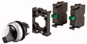 Drei Teile eines Schalters: ein Drehschalter mit silber-schwarzem Griff, ein Halterahmen und zwei elektrische Schaltelemente mit grünen Hebeln.