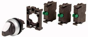 Ein grauer Schalter mit schwarzem Griff und drei dazugehörigen braunen Komponenten, die jeweils einen grünen Schalter besitzen.