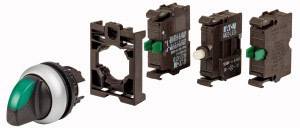 Schalter mit grünem Hebel und modularem Aufbau. Einzelteile des Schalters auseinandergebaut.