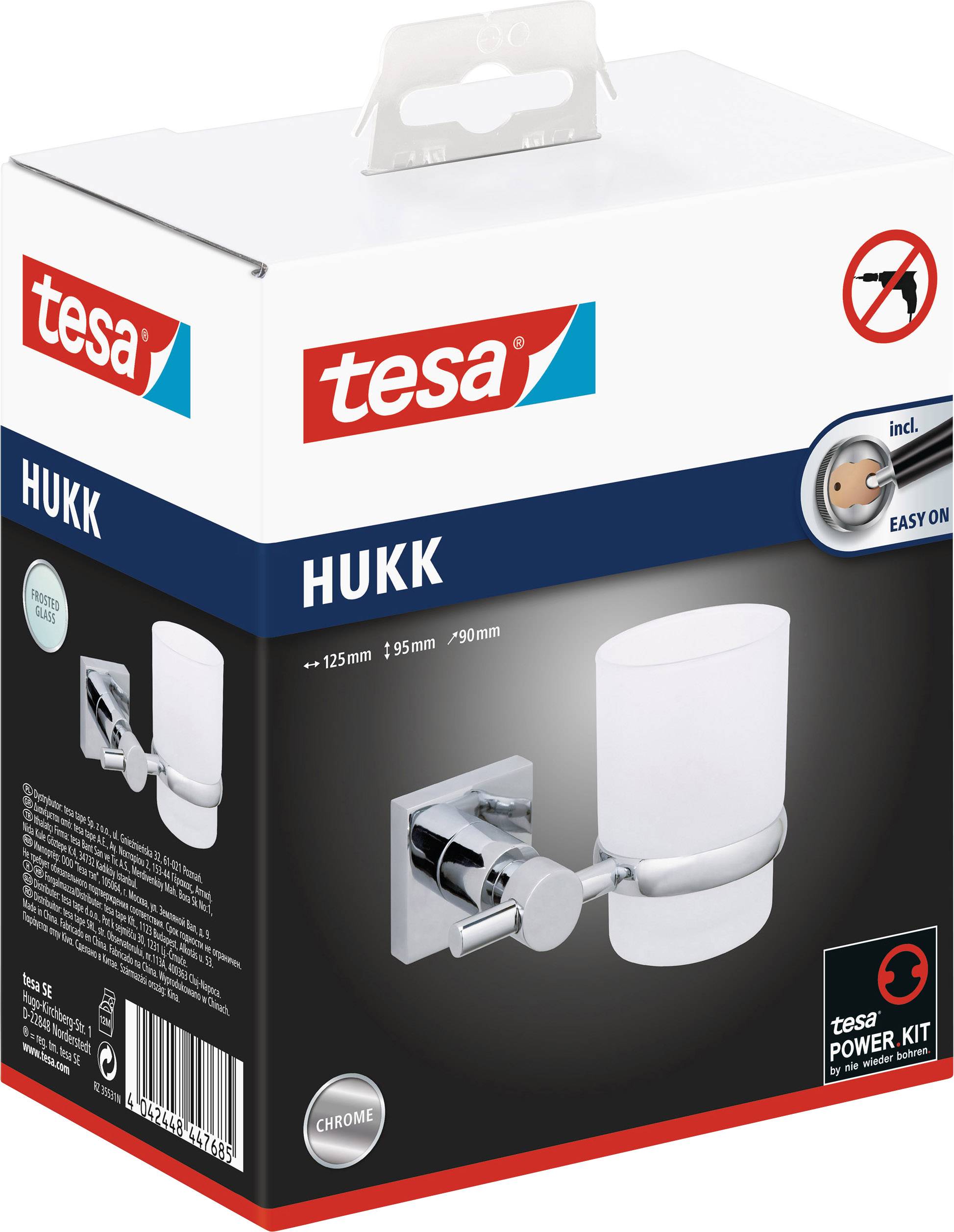 Verpackung eines Hukk Zahnputzbechers von Tesa, inklusive Power.Kit Befestigungssystem, zeigt Bild des Produkts in Chromausführung.