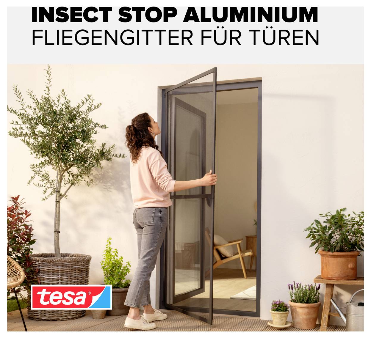 Werbeabbildung: Frau öffnet ein Tür-Fliegengitter aus Aluminium; Text 'INSECT STOP ALUMINIUM' und 'FLIEGENGITTER FÜR TÜREN', tesa-Logo.