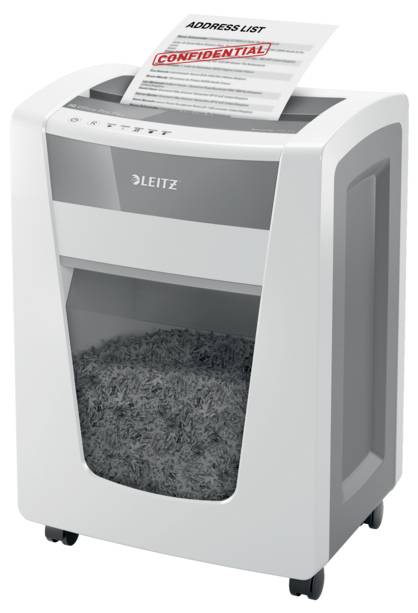 Ein Aktenvernichter, der ein Dokument mit der Aufschrift 'CONFIDENTIAL' zerkleinert. Theil zeigt das Papier und den Auffangbehälter voller Schnipsel.