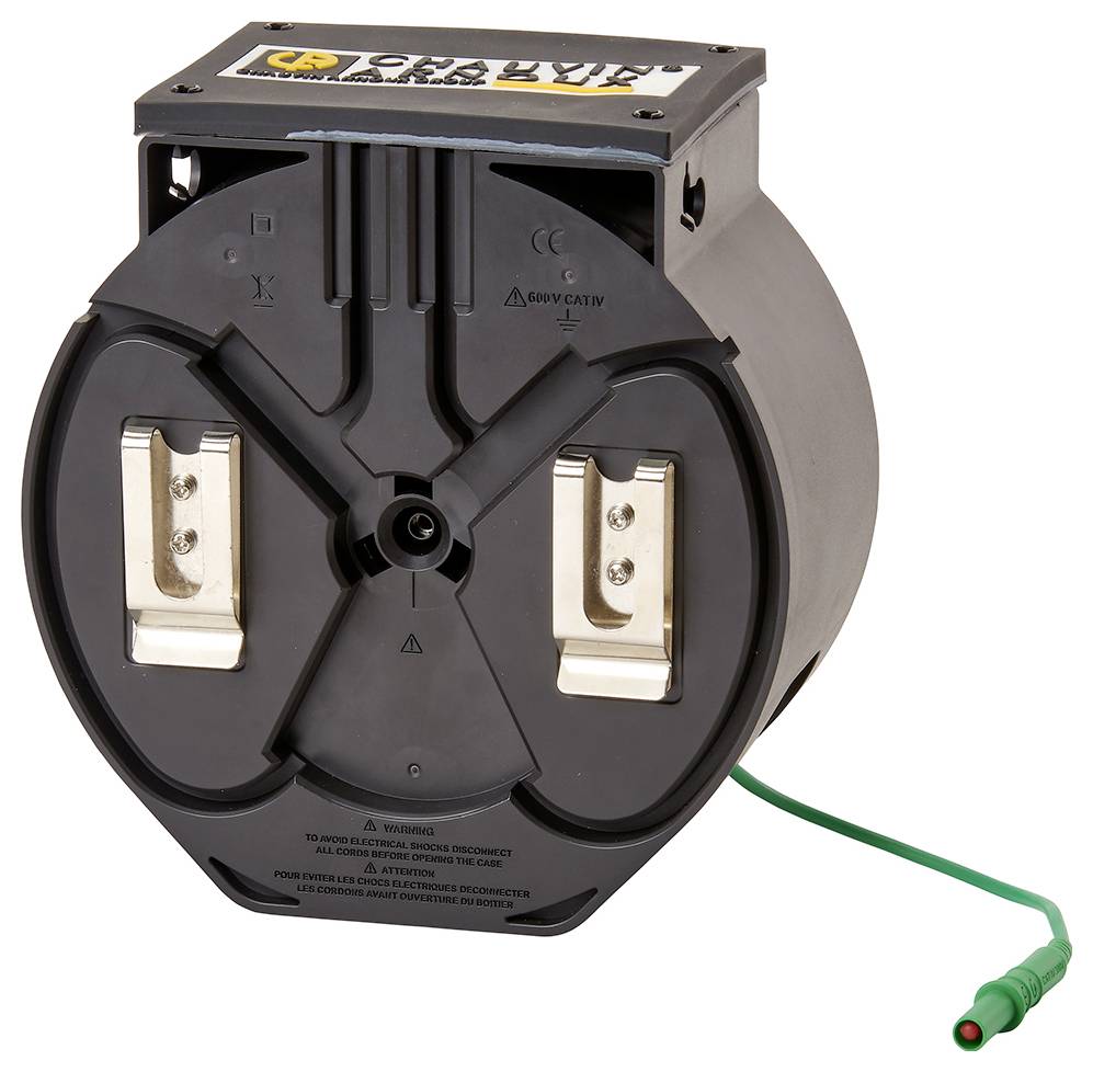 Ein schwarzer, runder Elektronikbauteil mit zwei Metallklemmen und einem grünen Kabel. Oberseite hat ein Logo und Symbole.