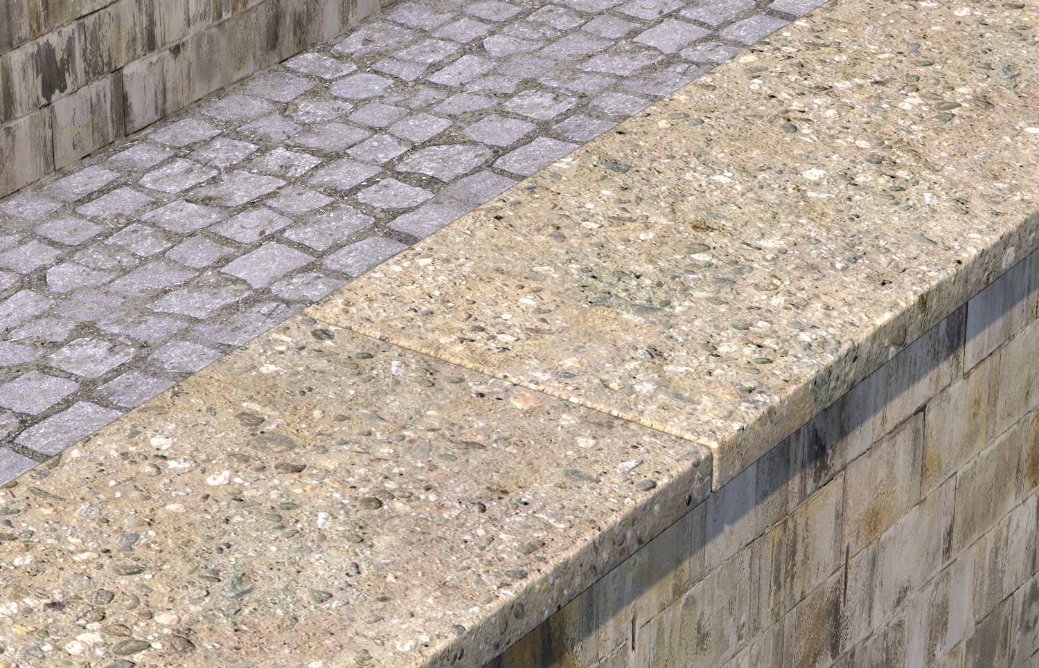 Eine Steinmauer mit einem flachen, breiten Abdeckstein aus Beton. Im Hintergrund sind Kopfsteinpflaster zu sehen.