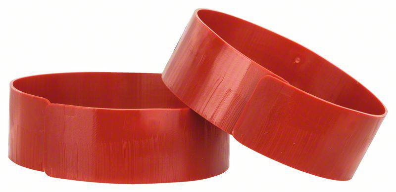 Zwei rote, runde Objekte liegen aufeinander. Sie haben eine strukturierte Oberfläche und ähneln breiten, flachen Ringen.