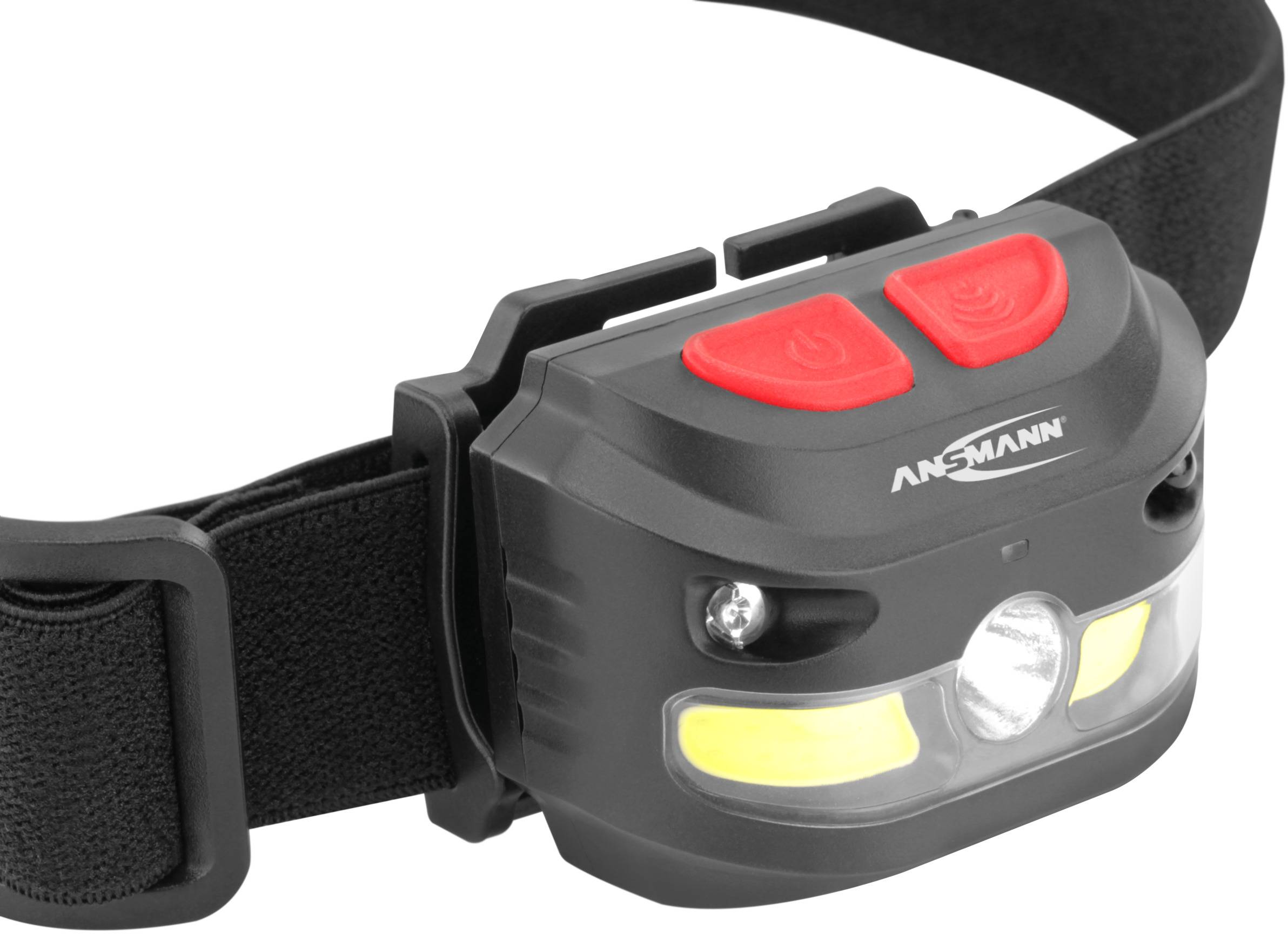 Schwarze Stirnlampe mit verstellbarem Band und zwei roten Knöpfen oben. Markenname 'Ansmann' ist sichtbar. Ideal für Freiluftaktivitäten.