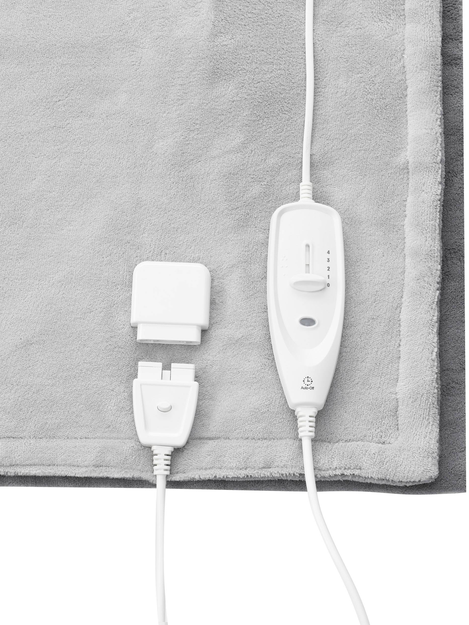 Elektrische Decke mit grauer Oberfläche und weißem Bedienelement. Schieberegler zur Temperatureinstellung und Steckverbindung sichtbar.