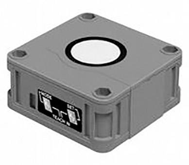 Grauer, quadratischer Sensor mit Anschlussfeld an der Vorderseite und runder Linse auf der Oberseite.