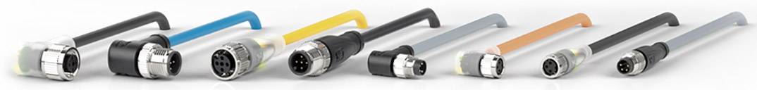 Mehrere industrielle Steckverbinder in verschiedenen Farben und Größen, nebeneinander auf einer hellen Oberfläche angeordnet.