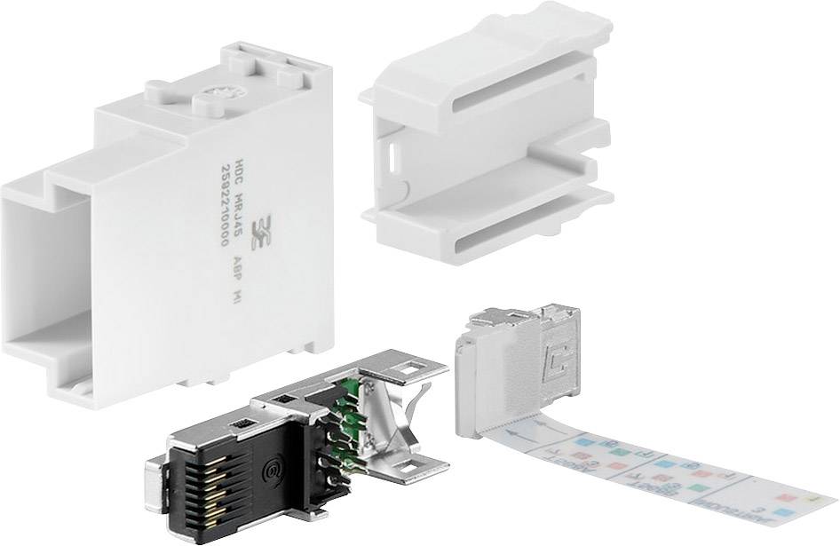 Mehrere Teile eines modularen Steckverbindersystems, darunter ein Gehäuse, Buchsenelemente und ein bedrucktes Etikett.