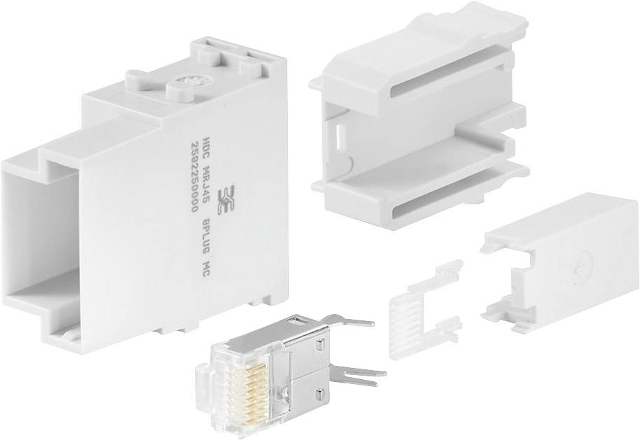 Mehrteiliger Kunststoffadapter in Einzelteilen dargestellt. Eine Eckverbindung, bestehend aus Steckelementen und einem RJ45-Modul.