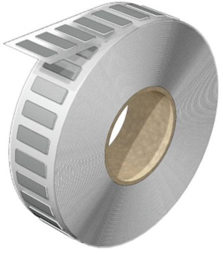 Eine Rolle silbernes Metallband mit rechteckigen Ausstanzungen, die sich spiralförmig abwickeln und industrielle Anwendung suggerieren.